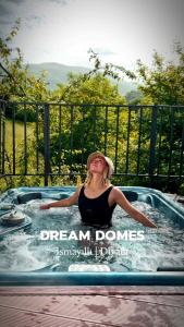 a woman in a jacuzzi in a hot tub at Dream Domes Luxury Glamping Tents in Gabala