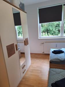 a bedroom with two beds and a mirror at Apartment Kapfenberg in Kapfenberg