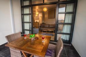 a dining room with a wooden table and chairs at 2 Sleeper with King Bed at Point Waterfront in Durban