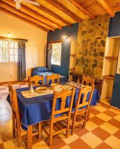 a dining room with a table and chairs at cabañas Villa de las rosas in Villa de Las Rosas