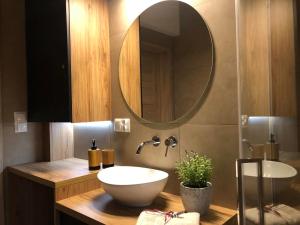 a bathroom with a sink and a mirror at Twoja Przystań SŁAWA- Apartament przy plaży in Sława