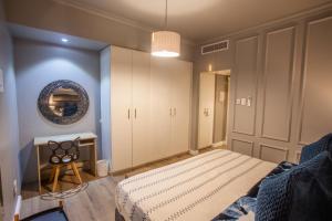 a bedroom with a bed and a mirror on the wall at 2 Sleeper with King Bed at Point Waterfront in Durban