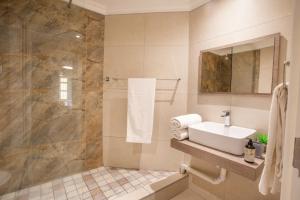 a bathroom with a sink and a shower at 2 Sleeper with King Bed at Point Waterfront in Durban +18 photos