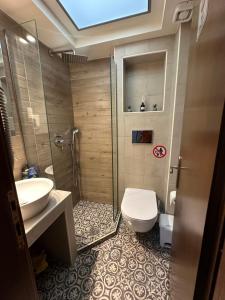 a bathroom with a toilet and a sink at Apartment GM in Neoi Epivates +9 photos