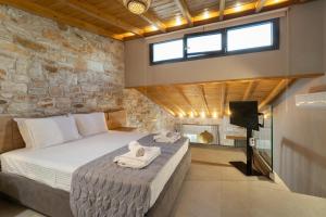 a bedroom with a bed with towels on it at Brothers Studios & Suites in Skala Potamias