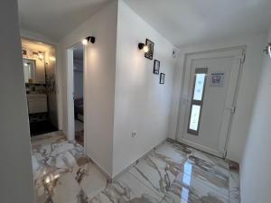 a hallway with white walls and a marble floor at Apartment Žega in Kaštela +15 photos