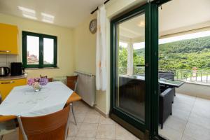 a kitchen and dining room with a table at HAUS RITA in Labin