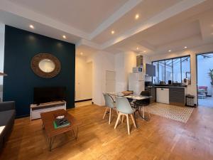 a living room with a couch and a table at Le Jeanne d'Arc - Appartements meublés in Gien