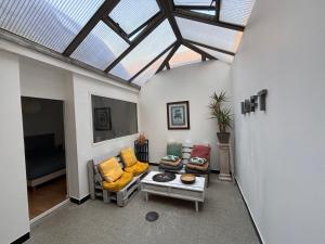 a living room with couches and a skylight at Le Jeanne d'Arc - Appartements meublés in Gien