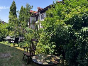 un jardin avec des chaises et une table ainsi qu'une maison dans l'établissement Cozy mountain apartament near the Gondola lift, à Bansko