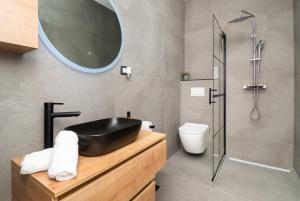 a bathroom with a black sink and a shower at Holiday house MAYA in Srima +16 photos