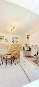 a kitchen with a table and a clock on the wall at Dignano in Vodnjan