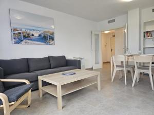 a living room with a couch and a table and chairs at Apto ATENAS, Retamar, Cabo de Gata in Almería