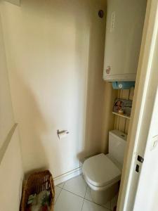 a small bathroom with a toilet and a cabinet at cozy two bed room flat near Champs-Élysée in Rueil-Malmaison