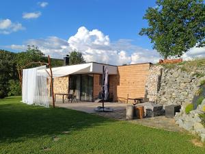 a building with a tent and a stone wall at Chata pod smrekmi in Hriňová