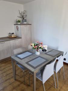 a dining room table with a vase of flowers on it at DA ARTU' in Udine
