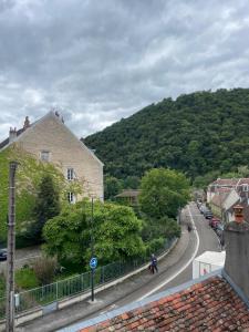 a person walking down a street in a small town at LE LOFT DU DOUBS in Besançon