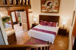 Postel nebo postele na pokoji v ubytování Hacienda San Nicolas de las Fuentes