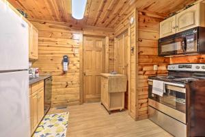 a kitchen with a stove and a refrigerator at Cozy Mountain Cabin in PERFECT location in Sevierville +21 photos