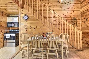 a dining room with a table and chairs and a staircase at Cozy Mountain Cabin in PERFECT location in Sevierville