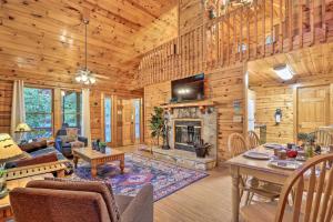 a living room with a fireplace in a log cabin at Cozy Mountain Cabin in PERFECT location in Sevierville