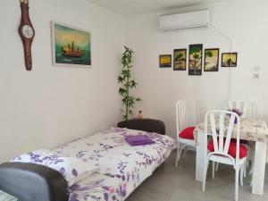 a bedroom with a bed and a table and chairs at Apartman Marinamar in Utjeha