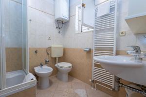 a bathroom with a sink and a toilet and a sink at Apartments ANIMA ex Marin in Podstrana +45 photos