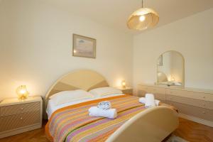 a bedroom with a bed with towels on it at Apartments ANIMA ex Marin in Podstrana