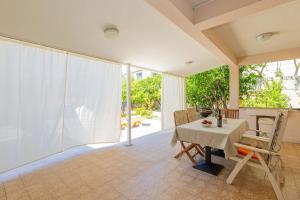 a dining room with a table and some chairs at Apartments ANIMA ex Marin in Podstrana