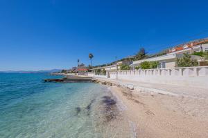 a beach next to the water with buildings at Apartments ANIMA ex Marin in Podstrana