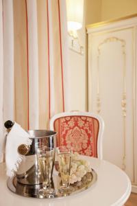 San Lio Tourist House في البندقية: طاولة عليها كأسين ودلو