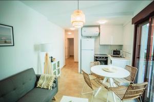 a living room with a couch and a table with chairs at Ondas do Mar Boutique Stays - Portonovo 1 in Portonovo