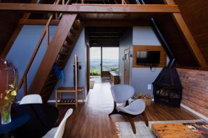 a living room with a staircase and a fireplace at Casa da Mata in São Bento do Sul