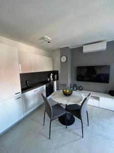 a kitchen with a table and chairs in a room at Rijeka Relax Apartment with parking in Rijeka