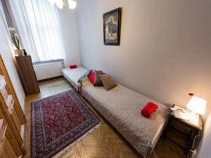 a room with two beds with red and blue pillows at 5 Bedroom Family Apartment in Krakow