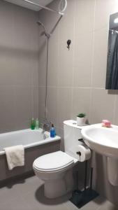 a white bathroom with a toilet and a sink at O Lar de Raxó in Raxó +19 photos