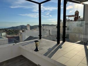 a balcony with a view of a city at La Casa Del Recreo in Cómpeta
