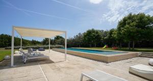 a swimming pool with a pavilion at Odegos Villa Aira in Torre dell'Orso