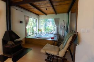 a bathroom with a tub in a room with a window at Casa da Mata in São Bento do Sul