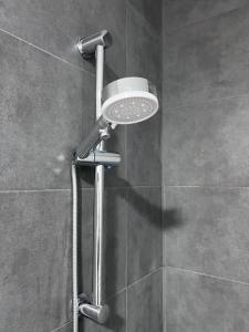 a shower with a shower head in a bathroom at Royal Racing Suite Top 3 near Red Bull Ring in Judenburg +5 photos