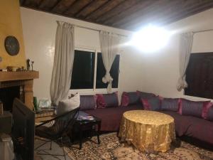 a living room with a couch and a table at FermeBao in Settat