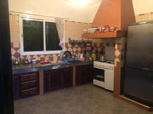 a kitchen with a sink and a stove at FermeBao in Settat +5 photos
