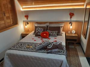 a bedroom with a bed in a small room at Chalé Sognare Uno in Santa Teresa