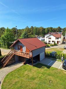 a house with a porch and a roof at Helios in Dębki