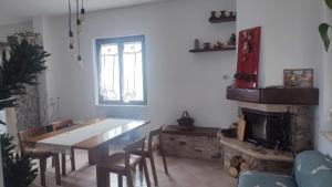 a dining room with a table and a fireplace at Orion House in Pianella