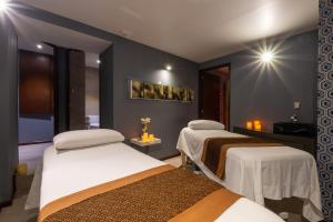Postel nebo postele na pokoji v ubytování 1850 Hotel Boutique