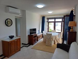 a living room with a couch and a table at Apartmani Saška 1 in Privlaka