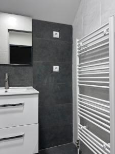 a bathroom with a sink and a mirror at Royal Racing Suite Top 5 near Red Bull Ring in Judenburg