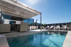 a pool with chairs and a table on a building at Holiday house MAYA in Srima
