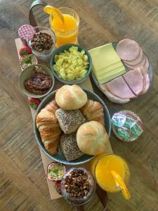 a table topped with different types of bread and other foods at Klein Boszicht in Rutten +14 photos
